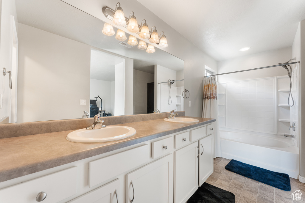 Bathroom featuring double vanity and shower / tub combo with curtain