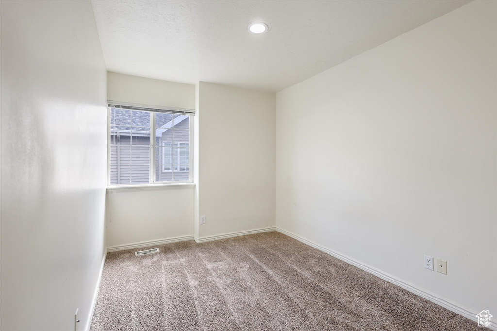 Unfurnished room featuring carpet floors, baseboards, and recessed lighting