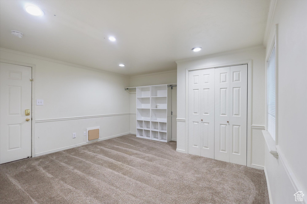 Unfurnished bedroom with carpet, ornamental molding, recessed lighting, a closet, and baseboards