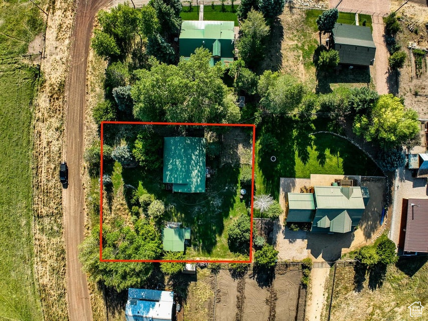 Aerial view of property and surrounding area with property parcel outlined