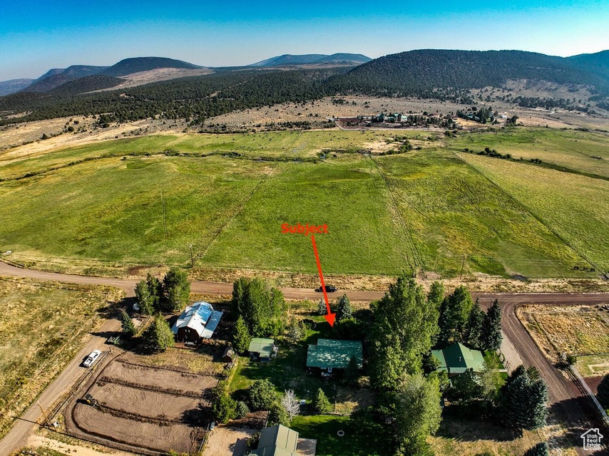 Aerial overview of property\'s location featuring rural landscape and mountains