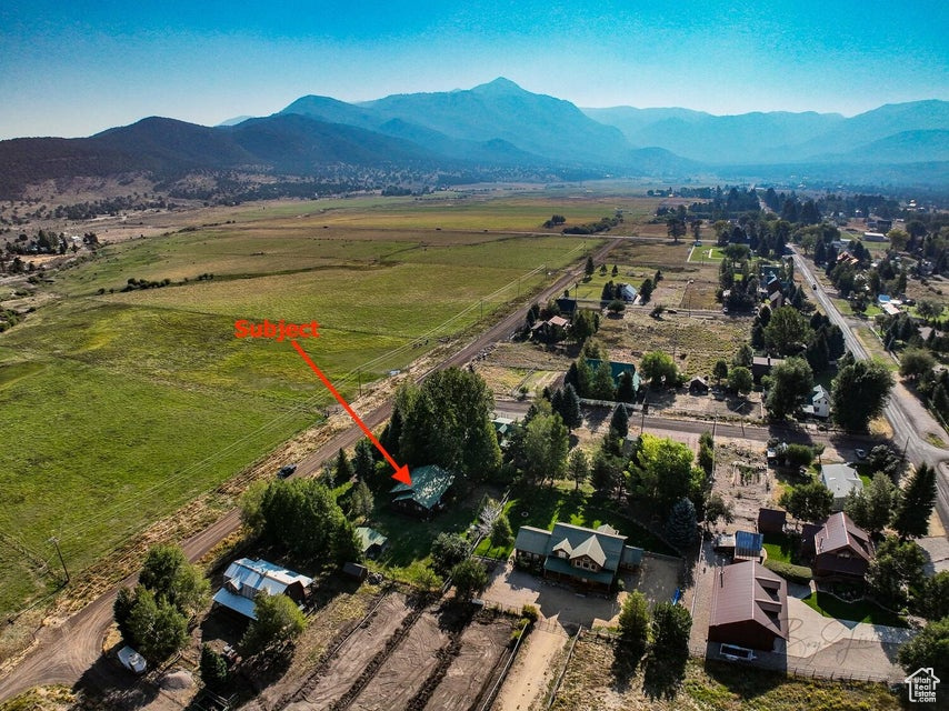 Aerial view of property and surrounding area with rural landscape and mountains