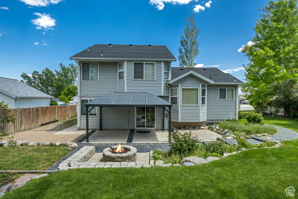 Back of house featuring a fire pit and a patio