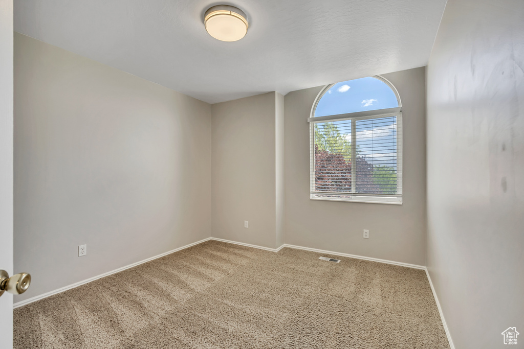 Unfurnished room with carpet floors and baseboards