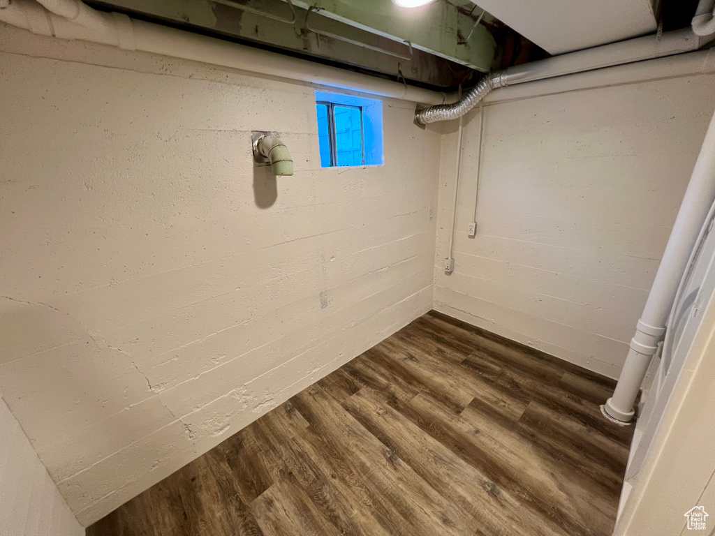 Basement featuring dark wood-style flooring