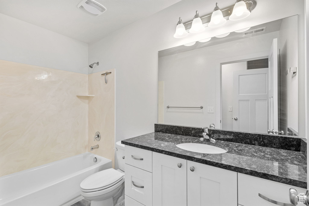 Full bath with vanity, shower / washtub combination, and toilet
