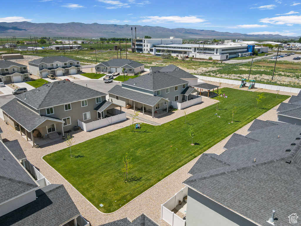 Aerial perspective of suburban area with a mountainous background