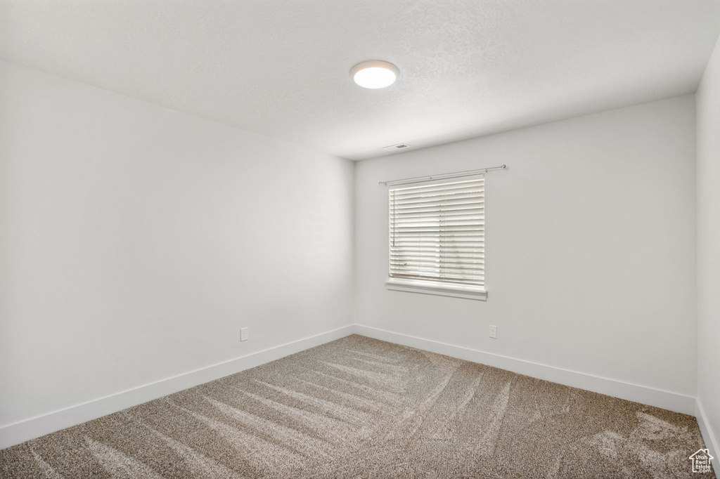 Spare room with carpet floors and baseboards