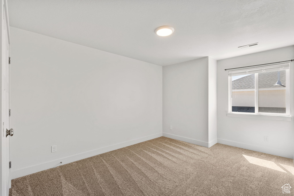 Unfurnished room with carpet and baseboards