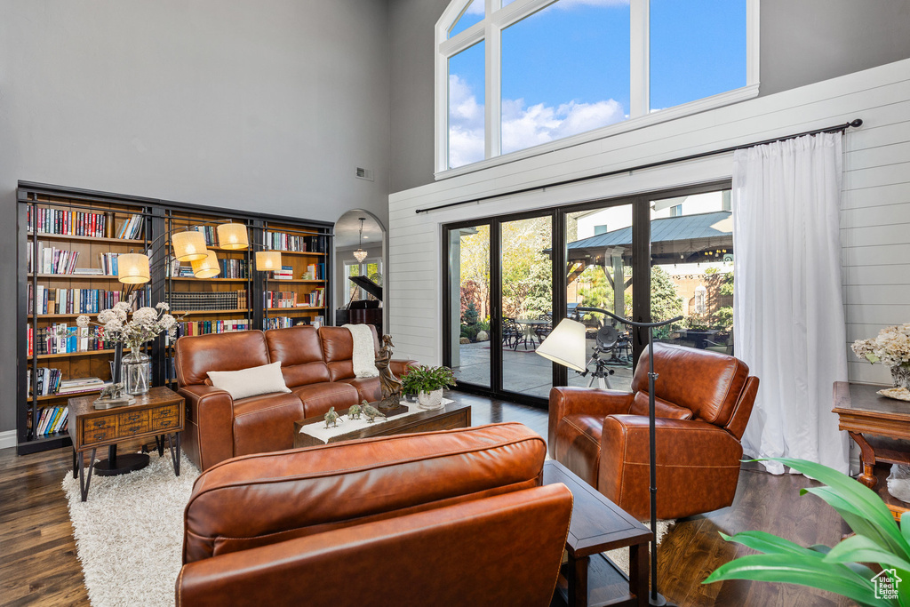 Living room featuring a towering ceiling and wood finished floors