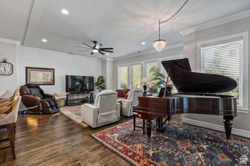 Living area featuring a ceiling fan, recessed lighting, wood finished floors, crown molding, and a textured ceiling