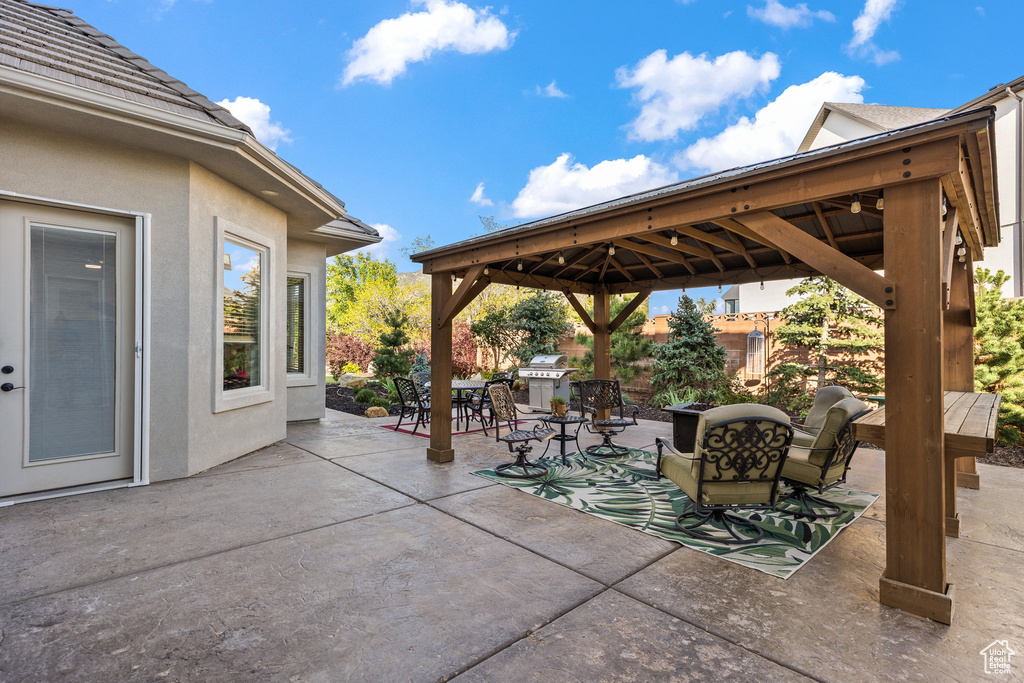View of patio featuring a gazebo and outdoor dining space