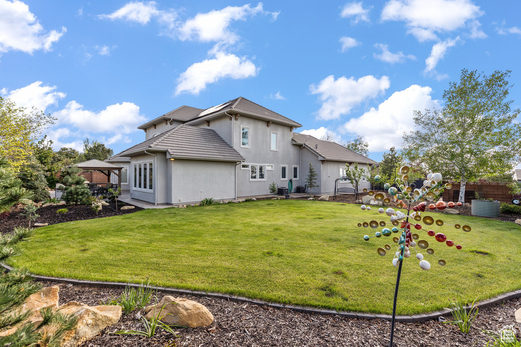 Rear view of property with a gazebo