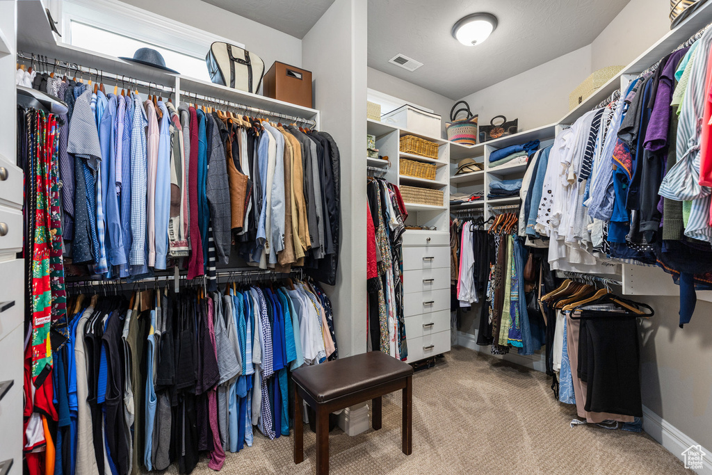 Walk in closet featuring carpet flooring