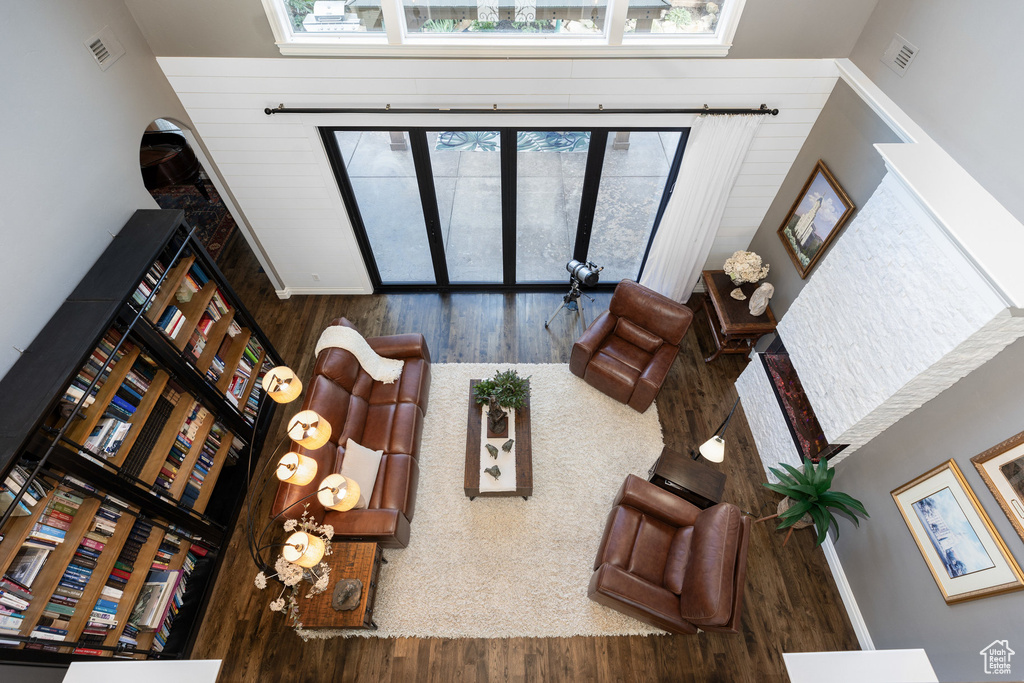 Living room featuring wood finished floors and a high ceiling