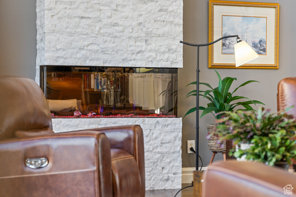 Sitting room featuring a multi sided fireplace
