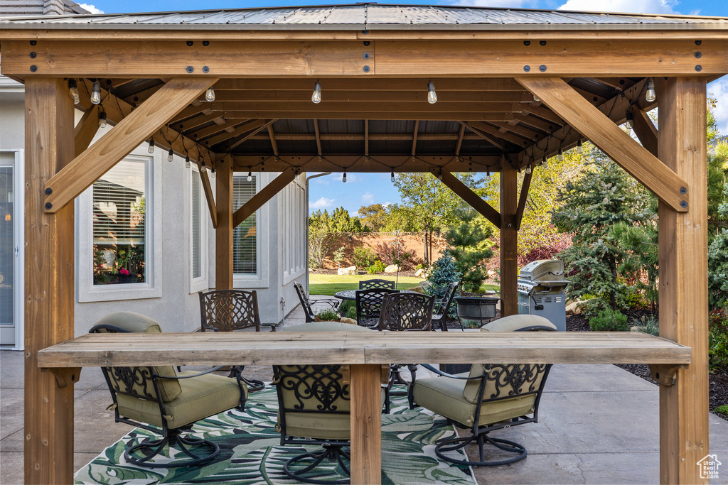 View of patio / terrace with a gazebo, area for grilling, and outdoor dining area