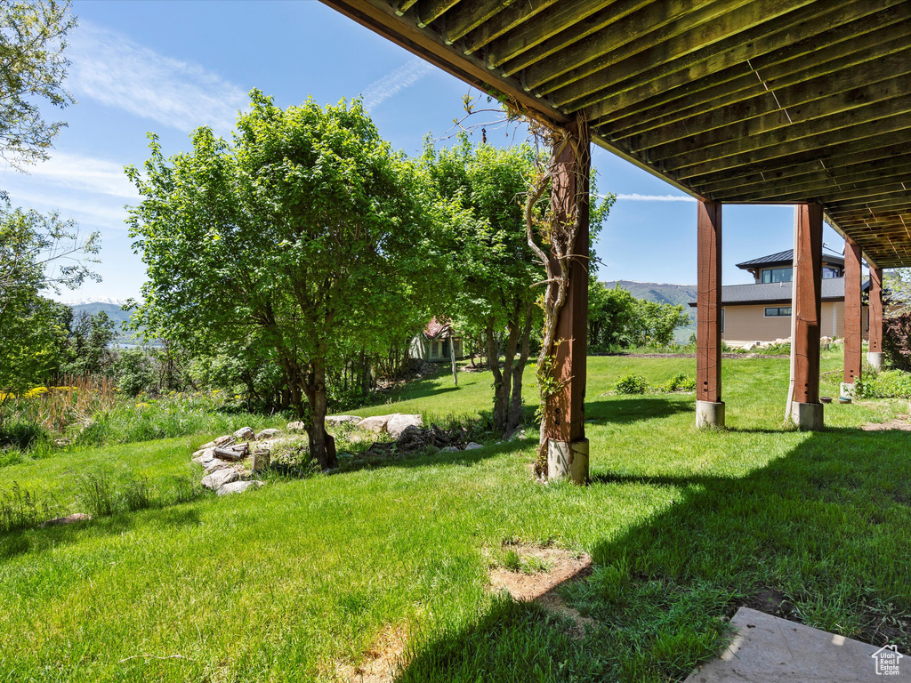 View of grassy yard with a mountain view