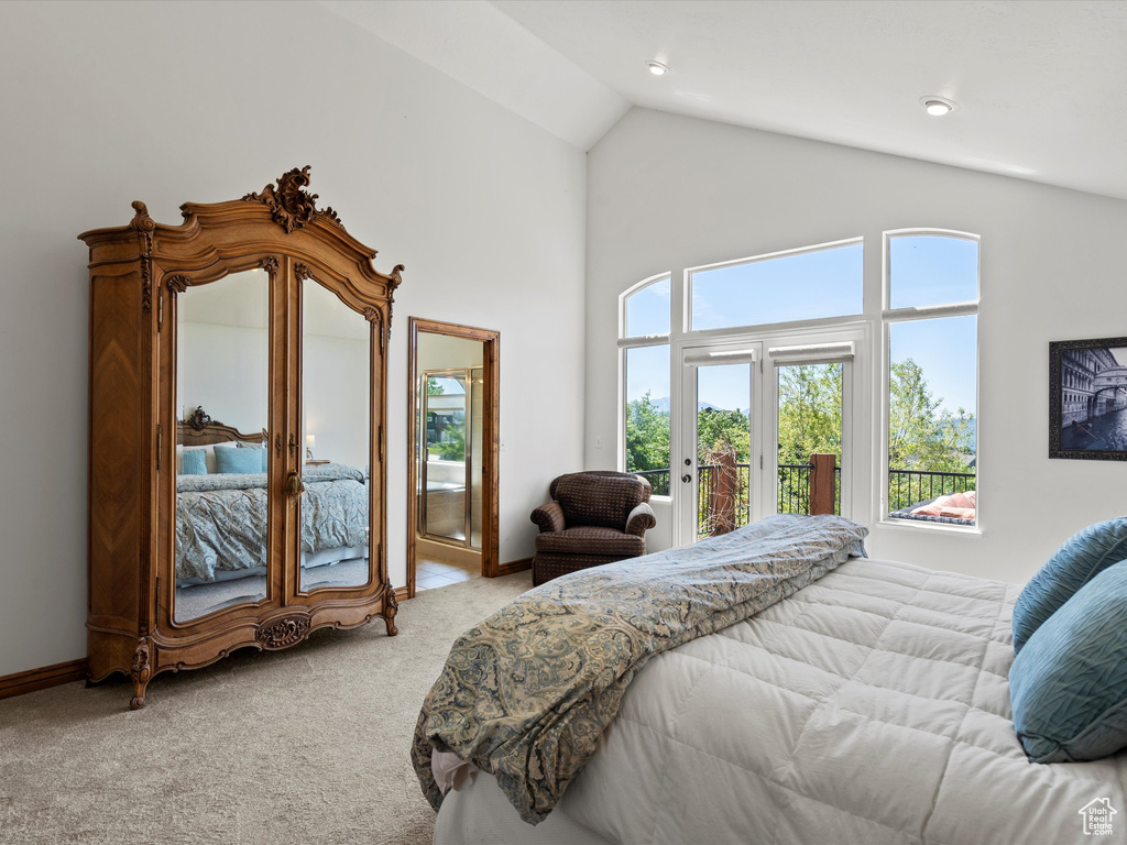 Bedroom featuring carpet flooring, access to outside, multiple windows, high vaulted ceiling, and french doors