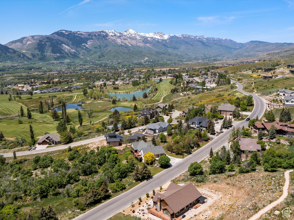 Aerial view of residential area featuring a water and mountain view and a golf club