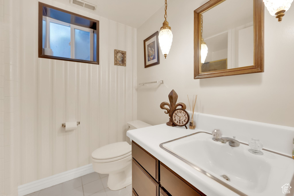 Bathroom featuring vanity, toilet, and tile patterned floors
