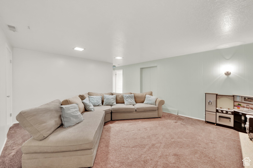 Carpeted living area featuring baseboards