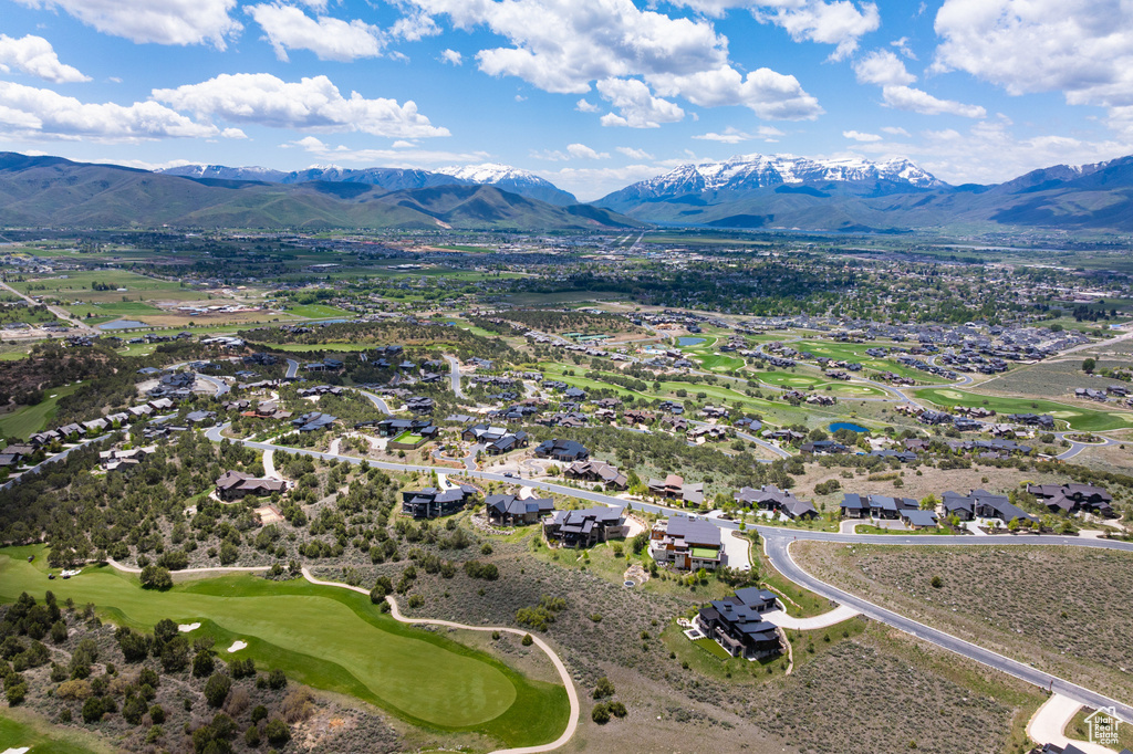 Aerial view of residential area featuring mountains and a golf club