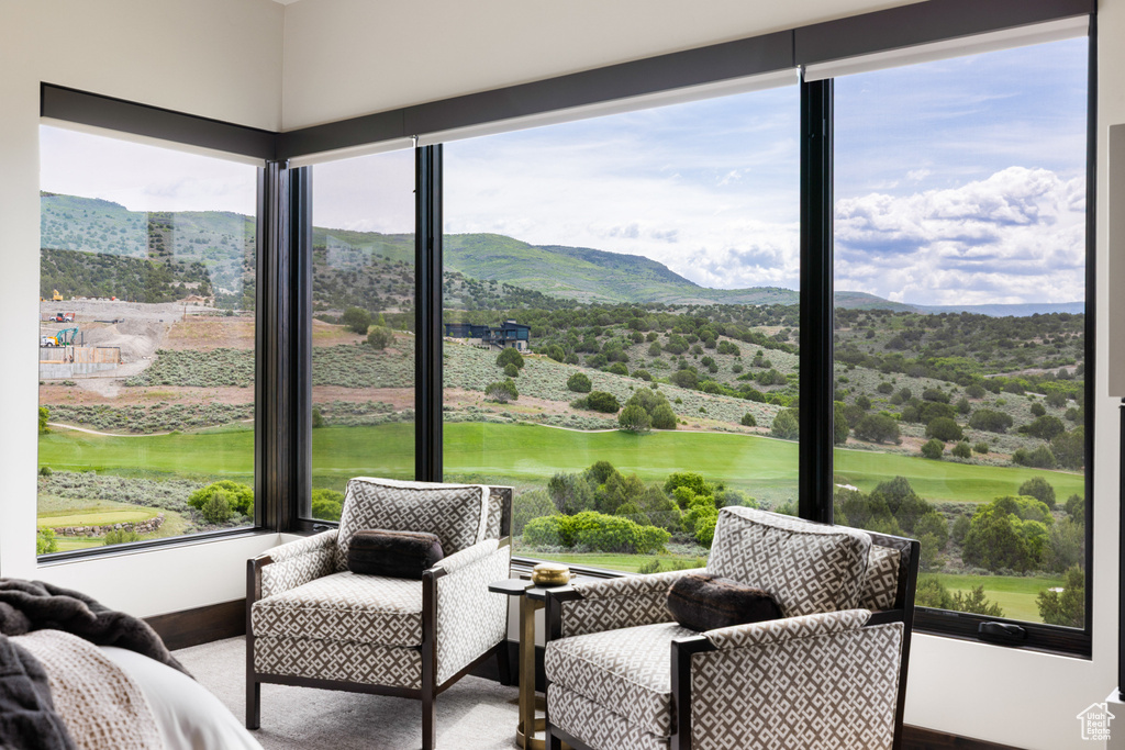 Sunroom featuring a mountain view and view of golf course