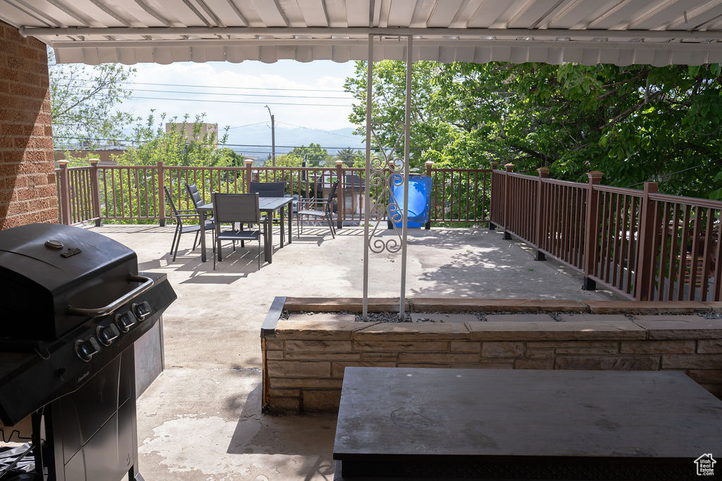 View of patio / terrace with grilling area, outdoor dining space, and a wooden deck