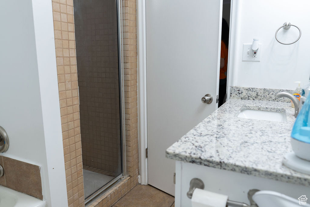 Full bathroom with a shower stall and vanity