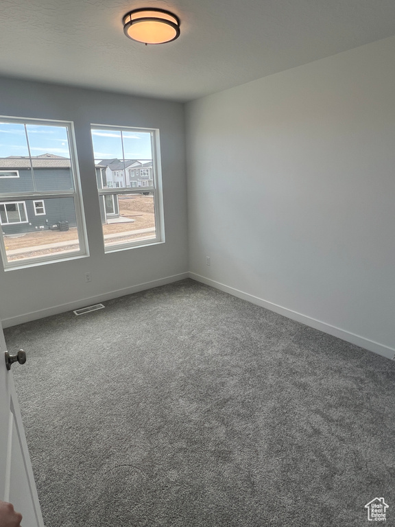 Unfurnished room with carpet and baseboards