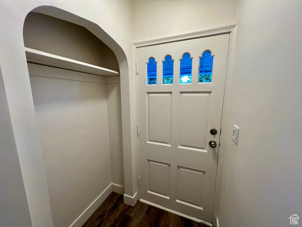 Foyer featuring dark wood-style floors and baseboards