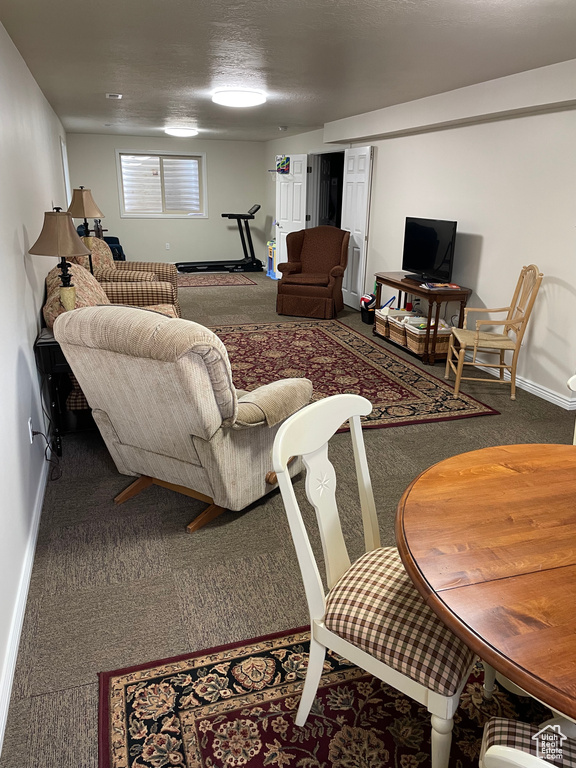 Living area with carpet and baseboards