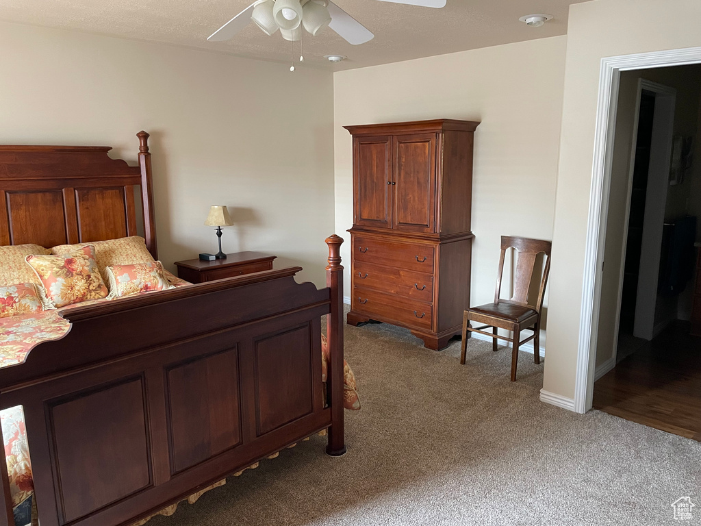 Bedroom featuring light carpet and a ceiling fan