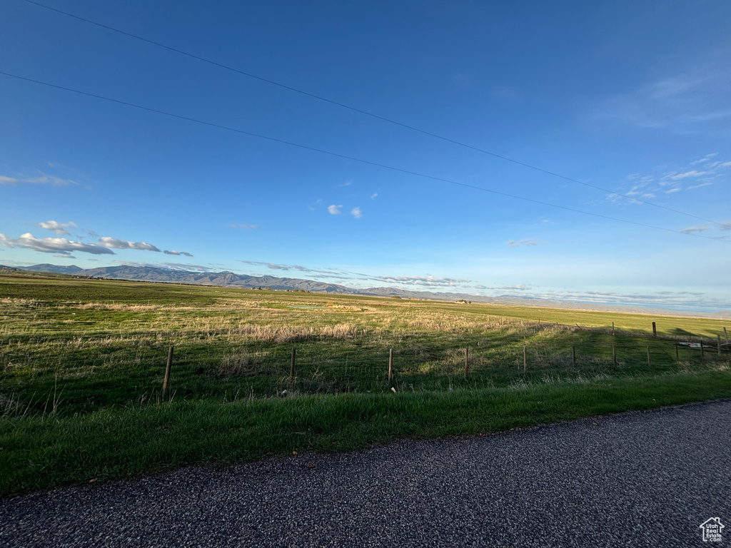 View of asphalt street with a rural view and a mountain view