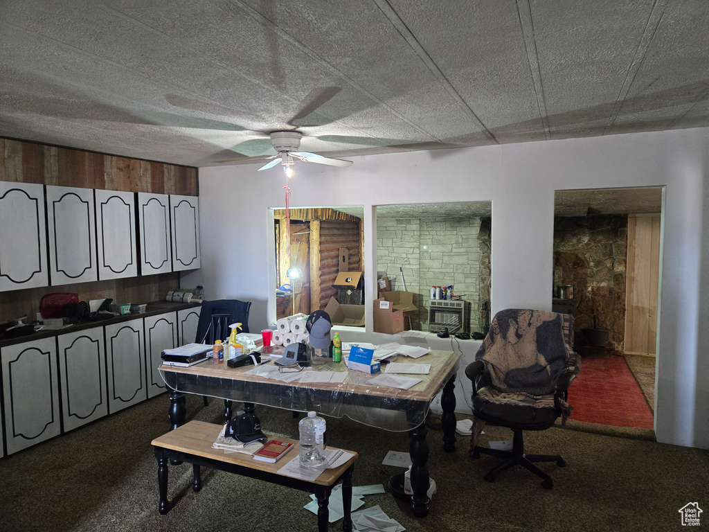 Dining area featuring ceiling fan and carpet floors