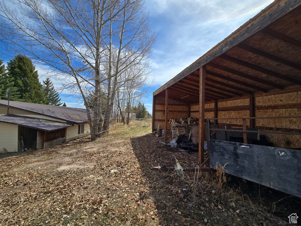 View of yard with a pole building and an outdoor structure