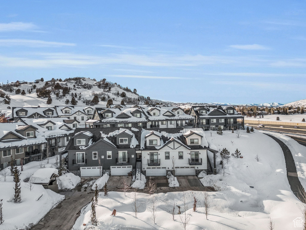 Snowy aerial view with a residential view and a mountain view