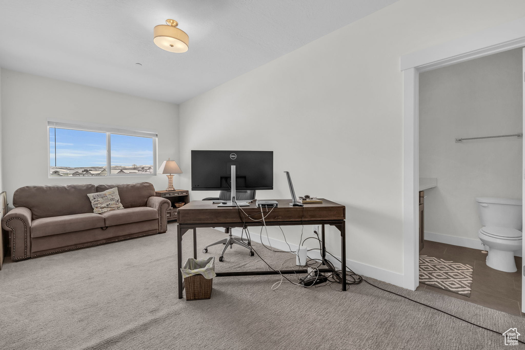 Carpeted office space with baseboards