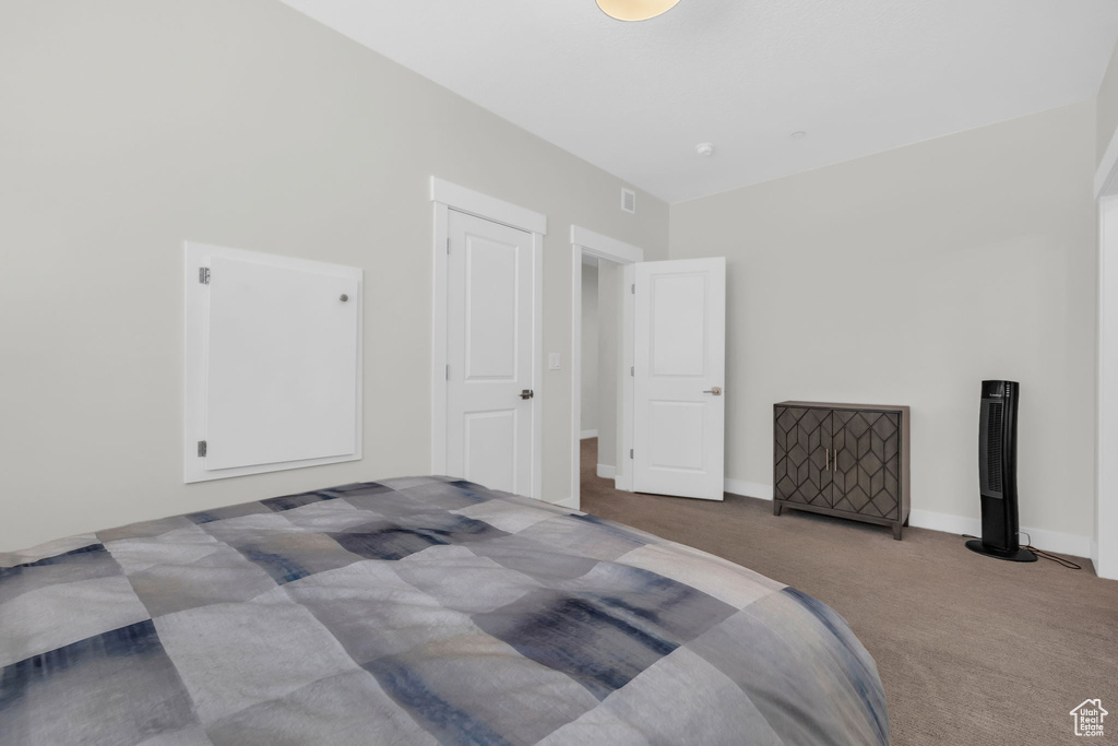 Carpeted bedroom with baseboards
