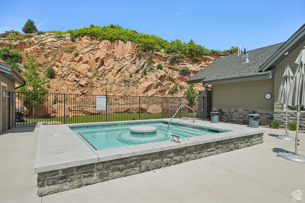 View of pool with an in-ground hot tub, a patio area, and a swimming pool