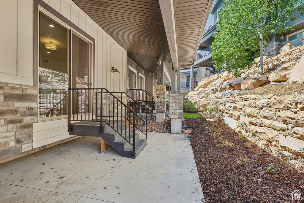 Doorway to property featuring board and batten siding