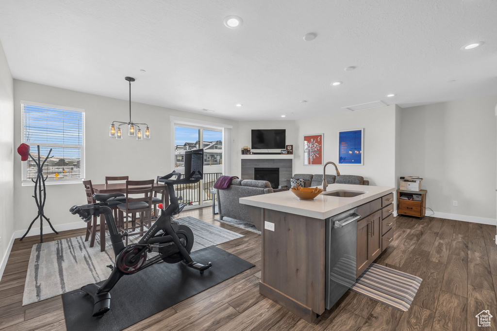 Kitchen with a sink, plenty of natural light, light countertops, baseboards, and recessed lighting