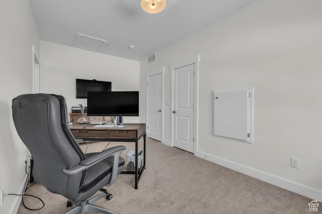 Office space featuring carpet flooring, baseboards, and attic access