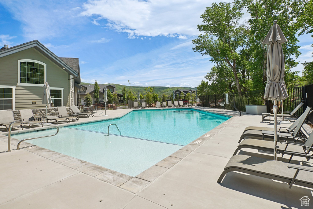 Community pool with a patio
