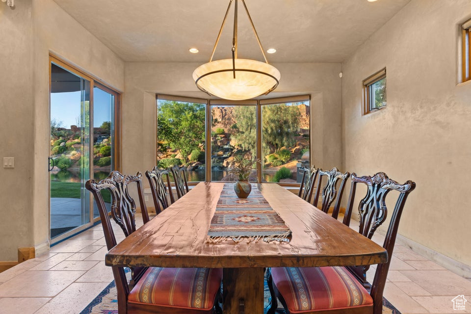 Dining area with stone tile flooring, plenty of natural light, recessed lighting, and baseboards