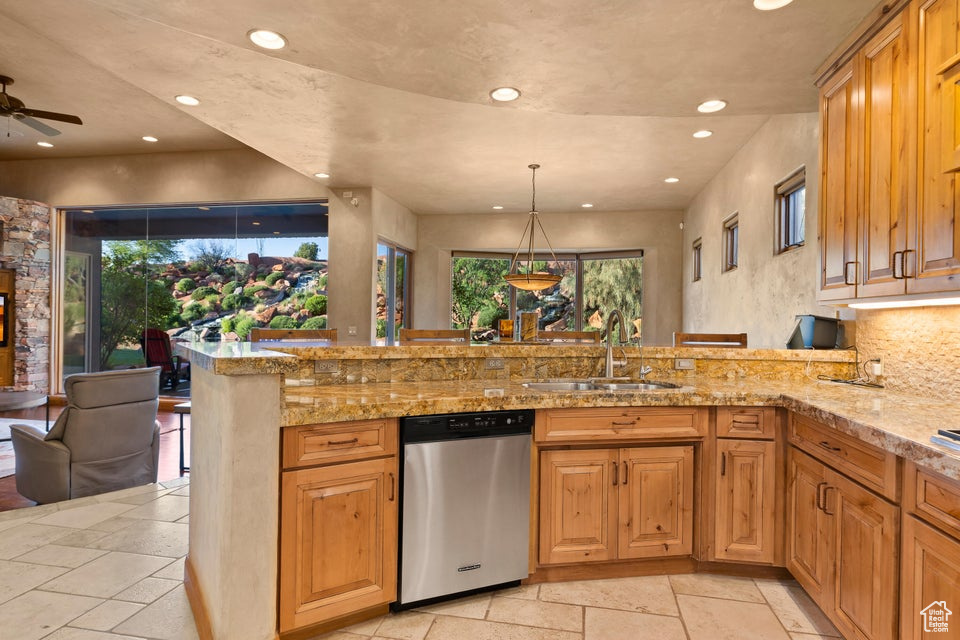 Kitchen with dishwasher, a sink, recessed lighting, stone tile floors, and healthy amount of natural light