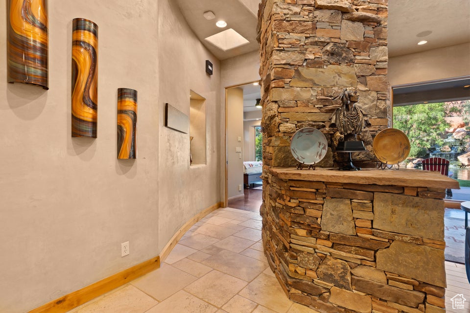 Hallway featuring a skylight