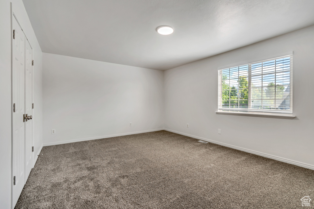 Unfurnished room with carpet floors and baseboards
