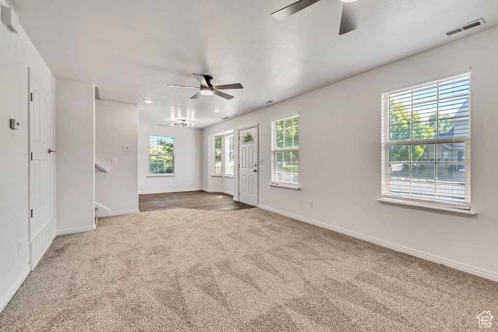 Empty room with a ceiling fan, carpet flooring, baseboards, stairs, and recessed lighting